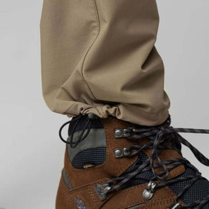 FjallRaven trouser hem with adjustable drawstring cord lock above brown hiking boot