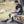 Athlete sitting on a bench applying a DonJoy cold therapy wrap to his knee