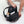 Person opening a black backpack containing a laptop, notebook, and metal water bottle