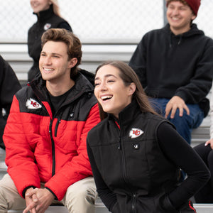 People wearing ActionHeat Kansas City Chiefs branded apparel sitting in stadium bleachers