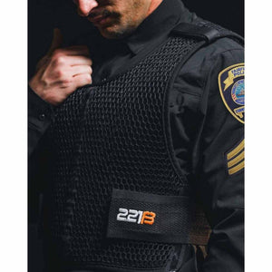 Officer wearing 221B Tactical black mesh vest over uniform