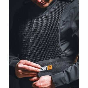 Person wearing 221B Tactical black mesh cooling vest over a black shirt