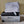 Mattress Cooler portable cooling unit with a grey quilted mattress pad folded on top