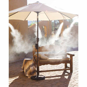 ExtremeMIST patio umbrella with integrated misting system over a wooden bench