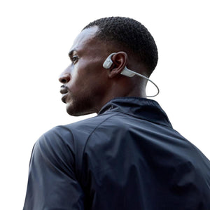 Man wearing white Shokz bone conduction headphones