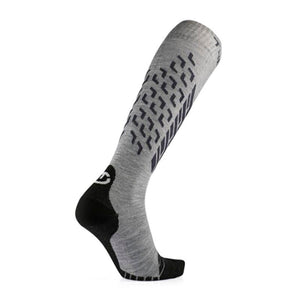 Therm-ic grey knee high ski sock with black heel and toe and geometric pattern on the calf