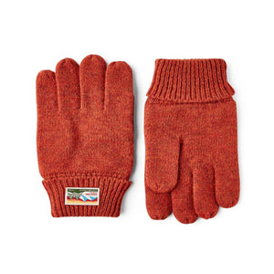 Hestra rust orange knit wool gloves with ribbed cuffs and branded patch