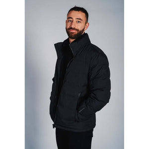 Man wearing a black 8K FlexWarm puffer jacket
