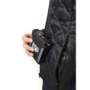 Hand holding a 30seven battery pack connected to a black quilted vest