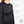 Black heated jacket showing breathable fabric moisture wicking mesh and battery pockets with Belgian and German technology