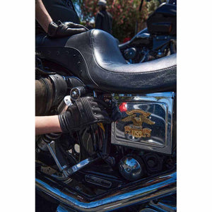 Person wearing Milwaukee Leather black gloves while sitting on a motorcycle