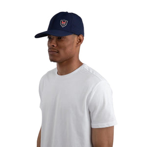 Person wearing a navy blue Mission baseball cap with a mesh back