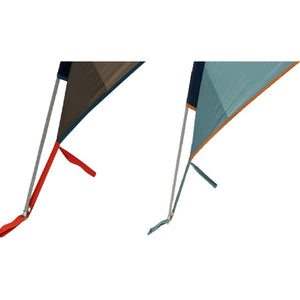 Close up of two tent corner stake out points with color coded webbing