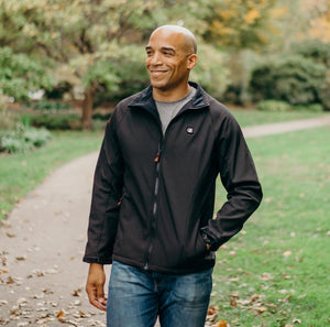 Man wearing a black ActionHeat heated jacket outdoors