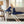 Woman sitting on a couch using a Woolrich navy blue electric heated throw blanket