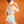 Person wearing a light blue Opal gel ice pack on their lower back