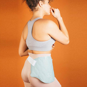 Person wearing a light blue Opal gel ice pack on their lower back