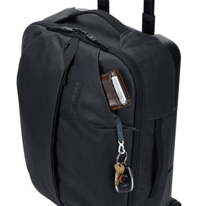 Thule black rolling luggage with wallet and keys in the front pocket