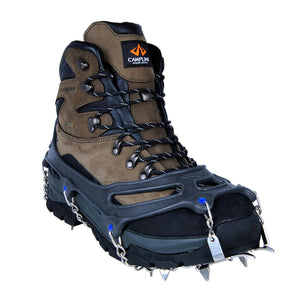 Snowline traction cleats attached to a brown and black hiking boot