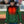 Man wearing a green Packers heated puffer jacket with glowing orange heating elements on the chest