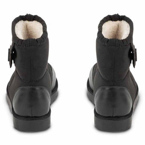 Back view of black 509 brand quilted ankle boots with white faux fur lining