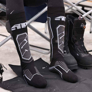 Person wearing black 509 brand knee high socks with white graphic patterns