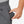 Hand placing a Venture Heat battery pack into the pocket of grey sweatpants