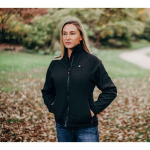 Woman wearing a black softshell heated jacket with a front zipper and pockets