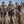 Three women wearing DSG Outerwear camouflage hunting gear holding ducks in a field