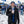 Man wearing ActionHeat jacket and New York Giants gear holding a hot drink in a snowy parking lot