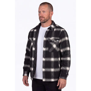 Man wearing a black and white plaid Mobile Warming flannel shirt over a white t-shirt