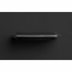 Side profile of a black Bellroy leather wallet on a dark background