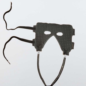 Black textured eye mask with adjustable straps and connected tubing