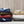 Stacks of folded Woolrich heated blankets in various colors with controllers
