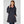 Woman wearing a navy Helly Hansen hooded rain jacket over a pink zip up fleece