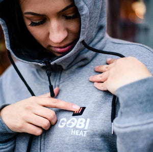 Person wearing a grey Gobi Heat zip up hoodie with black drawstring