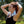 Woman wearing a white Alphacool portable neck fan outdoors