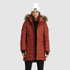 Outdoor Research rust colored hooded down parka with faux fur trim and white beanie