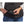 Person plugging a Therm-ic power bank into a heated vest pocket