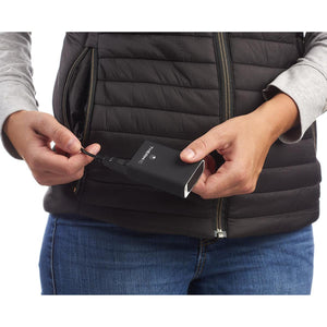 Person plugging a Therm-ic power bank into a heated vest pocket
