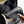 Hand pulling a grey Kuhl baseball cap from a Bellroy backpack compartment