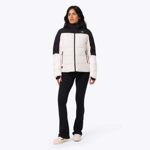 Woman wearing a white and black Mobile Warming puffer jacket with black leggings
