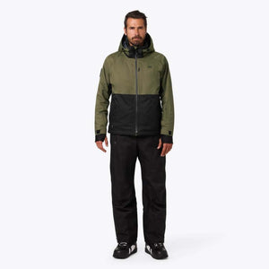 Man wearing Mobile Warming olive and black hooded jacket and black pants