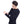 Man wearing a black Glovii long sleeve heated shirt with a control button on the sleeve