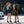 Two people standing on a city street wearing Thule travel backpacks