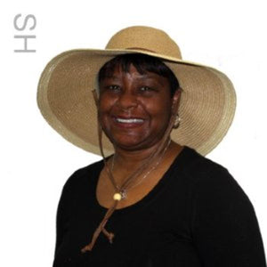 Woman wearing a wide brimmed straw hat by Polar Products