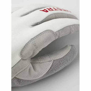 Close up of Hestra white and grey leather glove with red logo