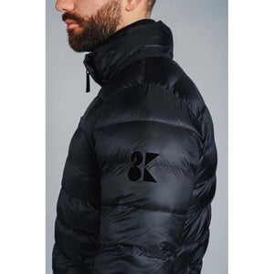 Man wearing a black 8K Tech Apparel puffer jacket with a high collar