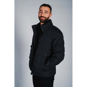 Man wearing a black 8K FlexWarm puffer jacket