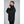 Man wearing black 8K FlexWarm heated jacket from side profile
